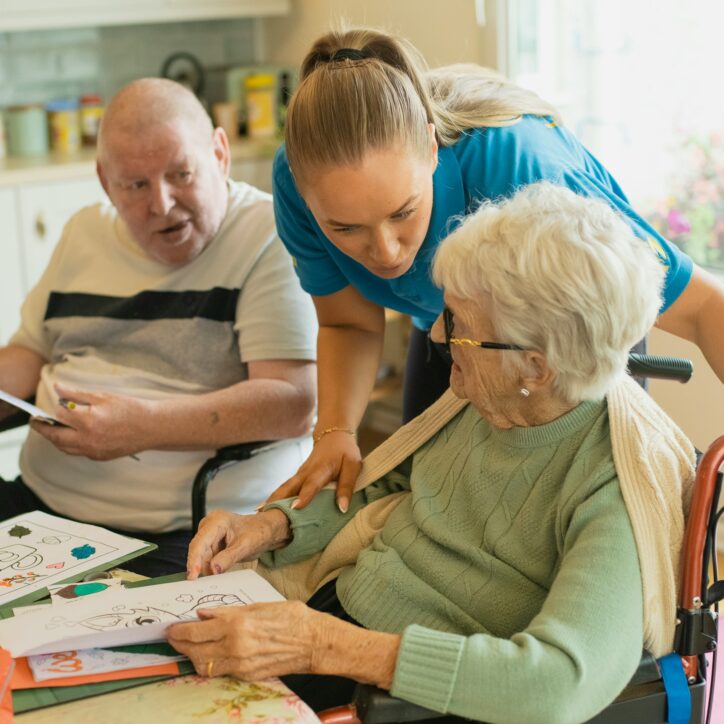 carer looking after two aged care patients